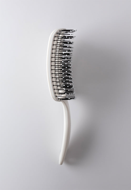 Flexi Brush has a curved comb shape with a flexible body