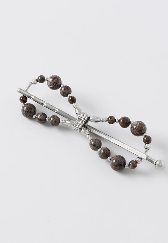 Unique curved pin design is made with natural brown snowflake jasper.