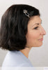 Flexi hair clip with diamond shaped celtic center design and montana blue accents in black hair