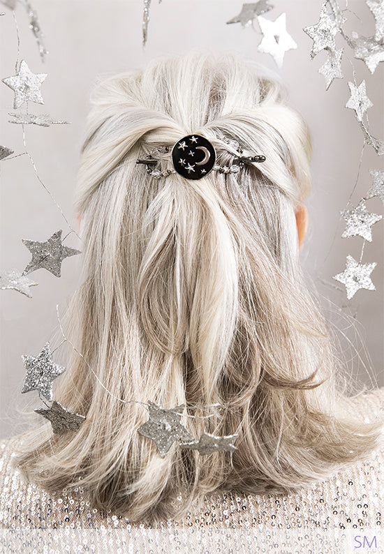 Flexi hair clip  with moon and stars shine bright through the dark night sky with accents of aurora borealis and star shaped beads shown in gray hair