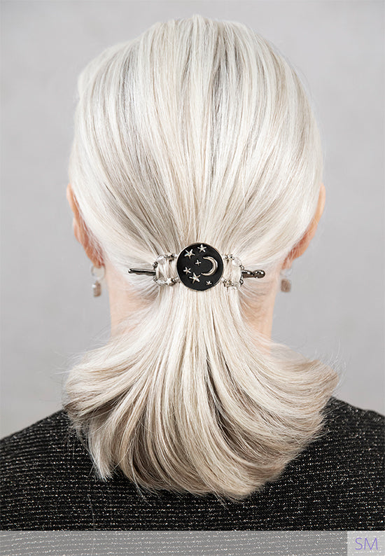 Flexi hair clip  with moon and stars shine bright through the dark night sky with accents of aurora borealis and star shaped beads shown in gray hair