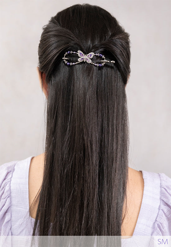 Flexi with butterfly and delicately detailed wings and lavender and purple pearls in black hair