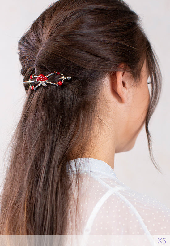 Flexi hair clip with mushroom with a bright red cap and matching beads in brown hair