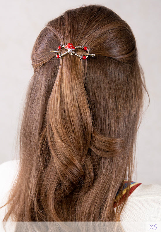 Flexi hair clip with mushroom with a bright red cap and matching beads in brown hair