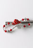 Flexi hair clip with mushroom with a bright red cap and matching beads.