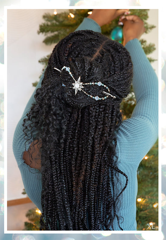 Flexi hair clip with star and crystals and a frosted clear center with nebula green accents in black braided locs