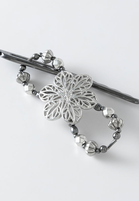 Winter filigree flower with mixed metal accents.