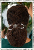 Antique wreath adorned with crystals and pearl accents shown in Sister Locs