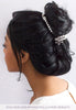Hair styled with a mix of a flower hair pin and pearl hairband.
