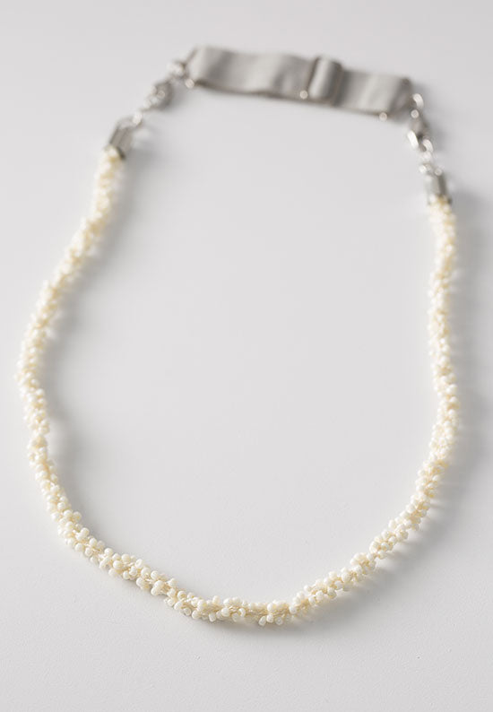 Elegant ivory pearl seed cluster hairband worn as necklace.
