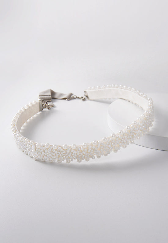 Elegant white pearls on a white band.